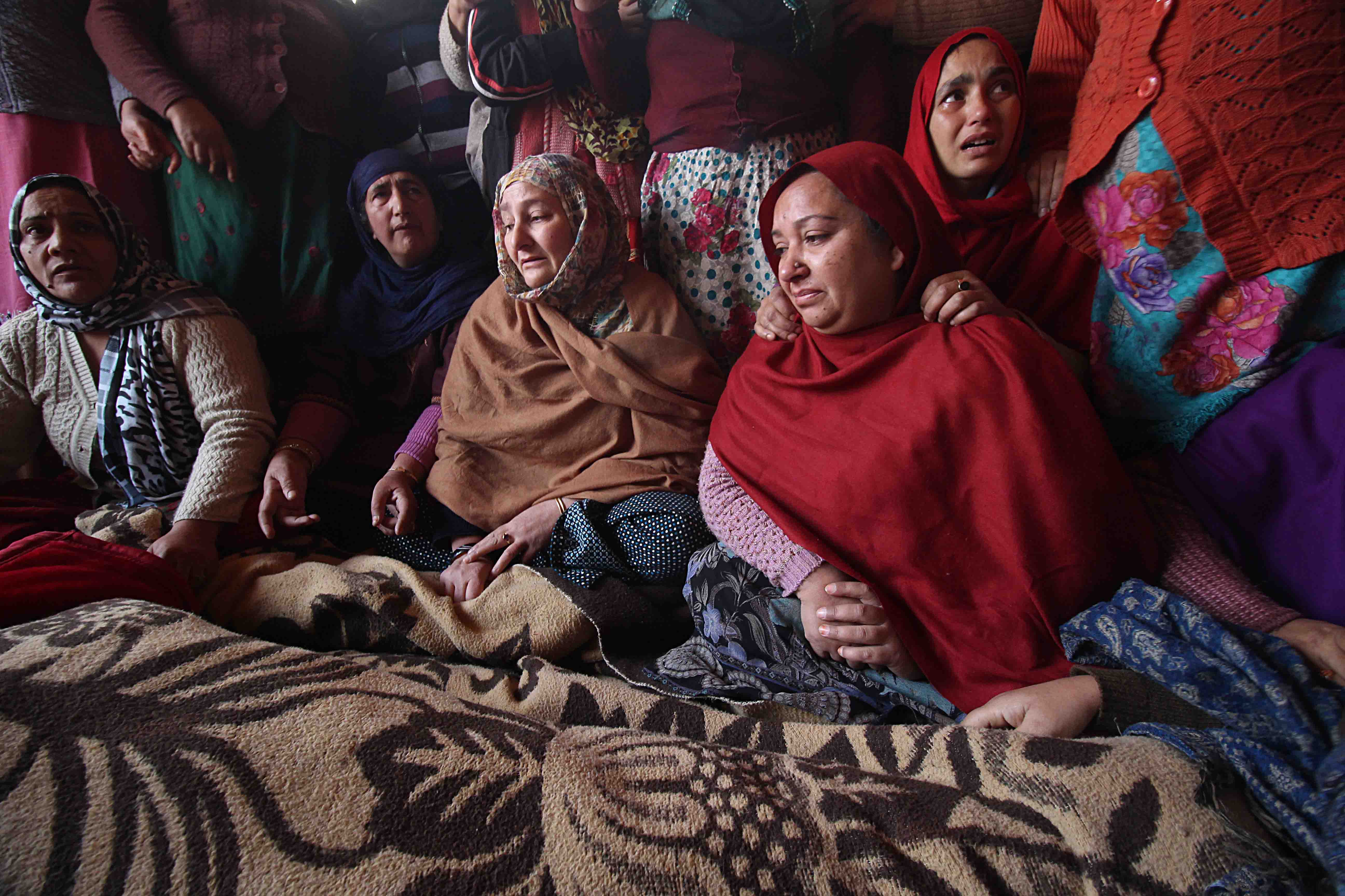 Family members of Shalimar teenage boy, who, according to his family, was killed by the police. Photo: Faisal Khan 