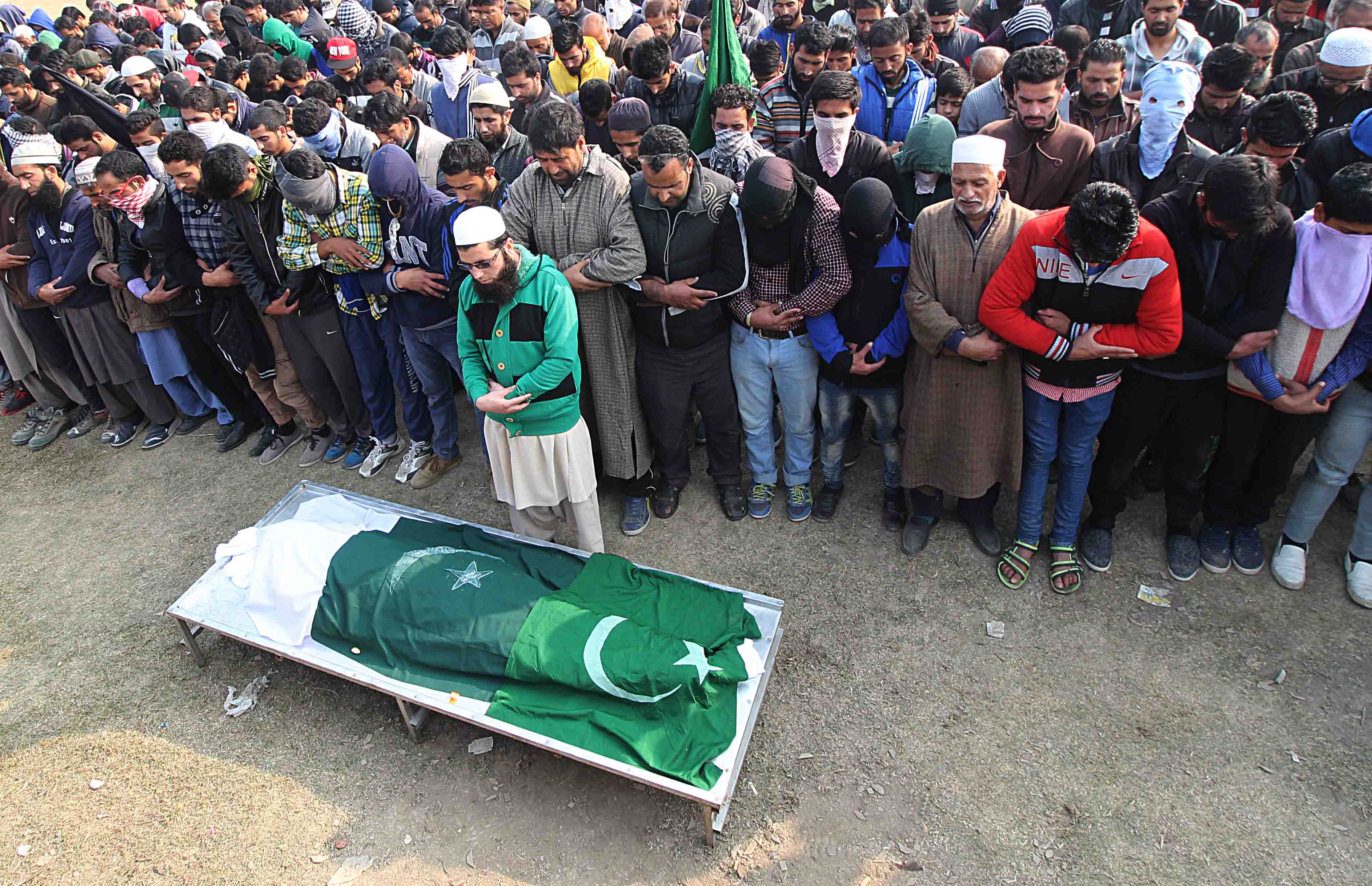 People supplicate for the deceased at the funeral prayer in Eidgah. Photo: Faisal Khan 