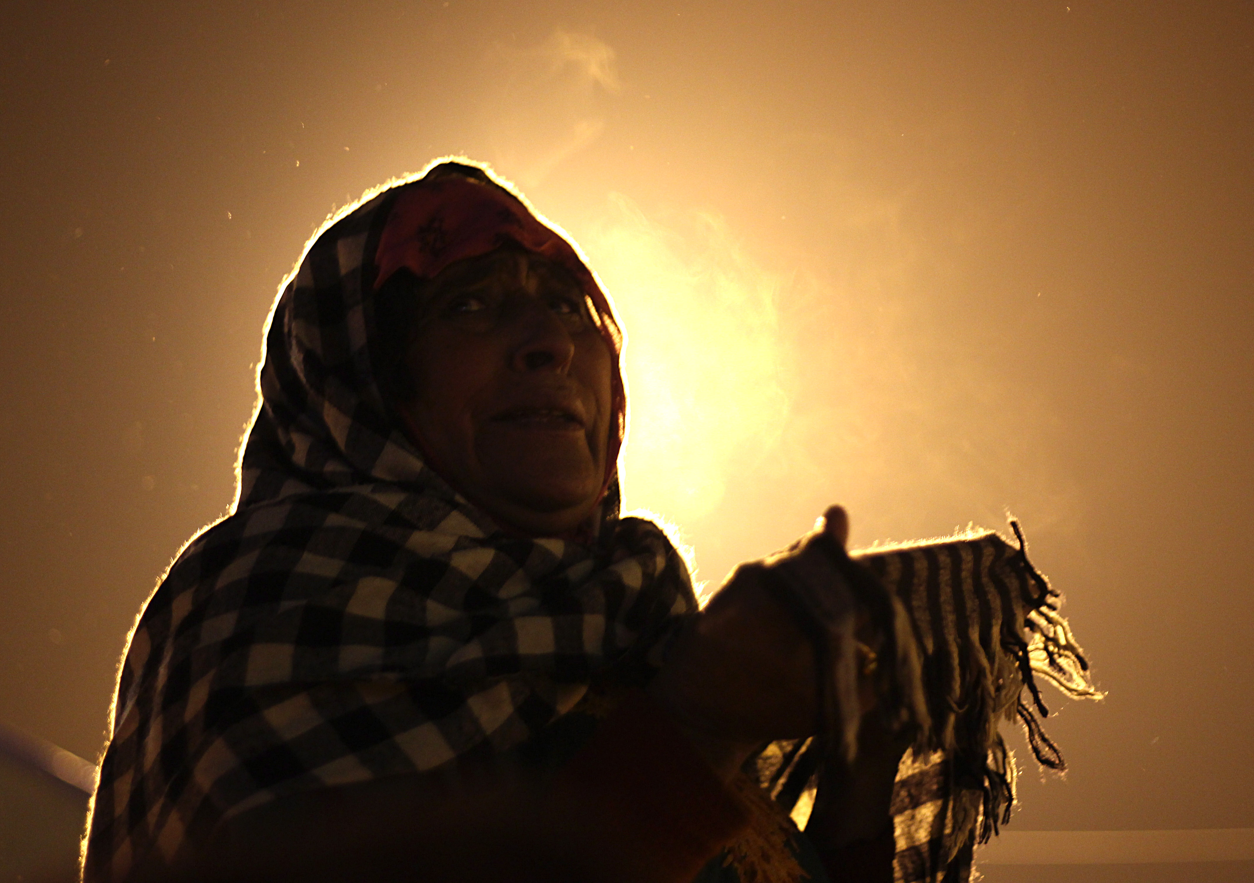 A Kashmiri Muslim woman prays before the dawn prayers during a ceremony marking the birthday anniversary of Prophet Mohammad, Mawlid al Nabi, at the Hazartabal shrine in Srinagar, the summer capital of Indian controlled Kashmir, on December 12, 2016.